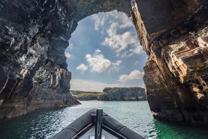 The bow of a boat near a cliff